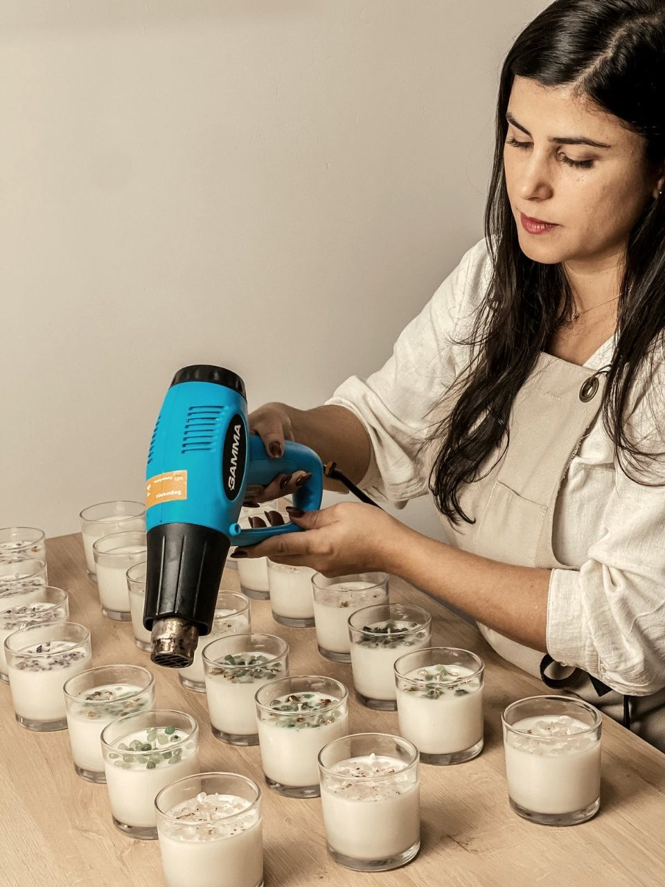 Cinara aplicando soprador térmico nas velas — técnica de acabamento